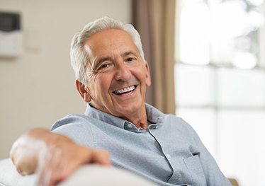 an older man smiling with a brand-new smile