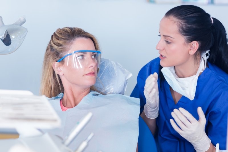 dentist explaining how to prevent dry socket to patient