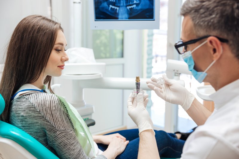 Patient talking to dentist about dental implants